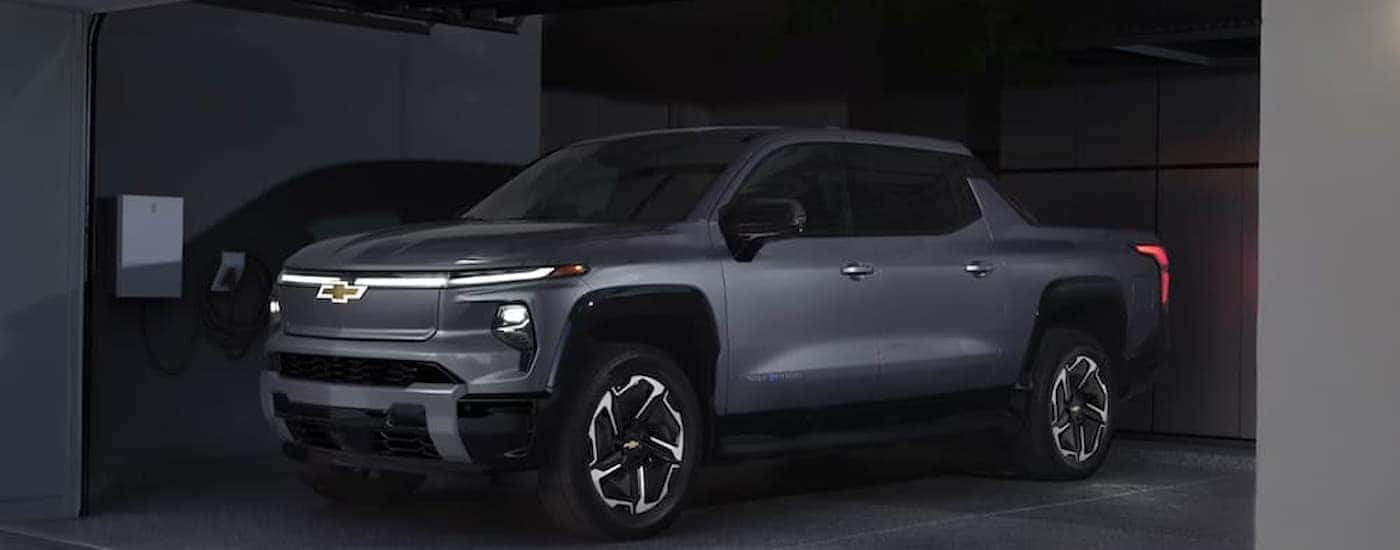 A gray 2025 Chevy Silverado EV in a garage charging