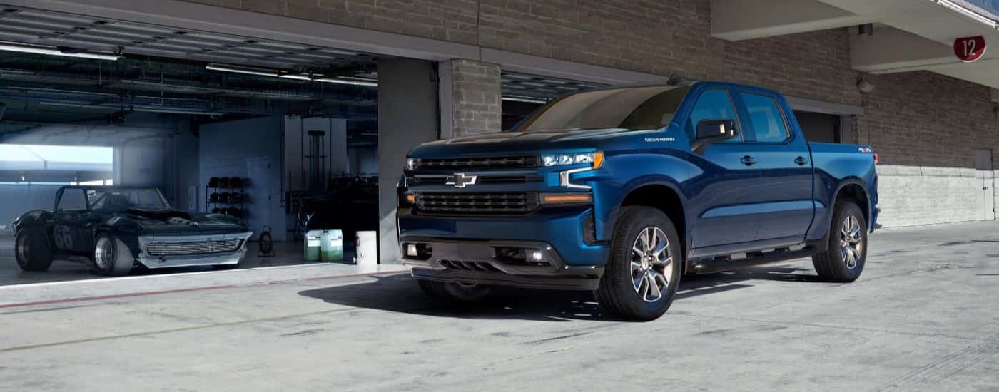 Blue 2019 Chevy Silverado 1500 for sale near Troy parked in front of a garage