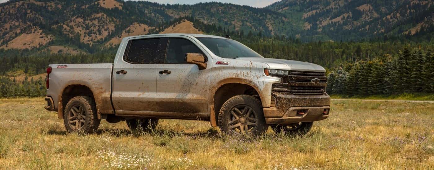 Silver 2019 Chevy Silverado off-road covered in mud