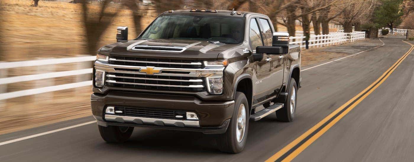 Brown 2020 Chevy Silverado 2500HD driving to look at used trucks for sale