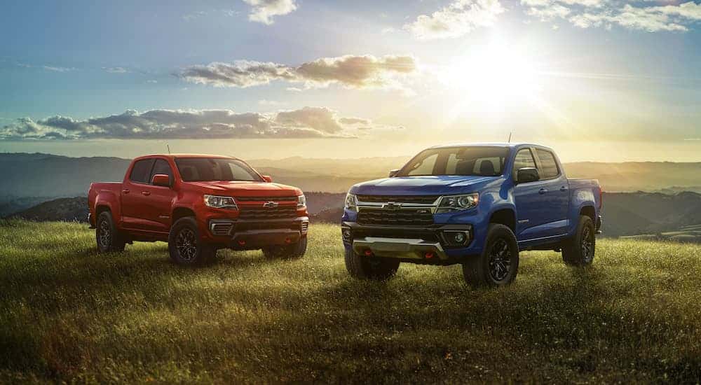 Two 2022 Chevy Colorados parked side by side in a field