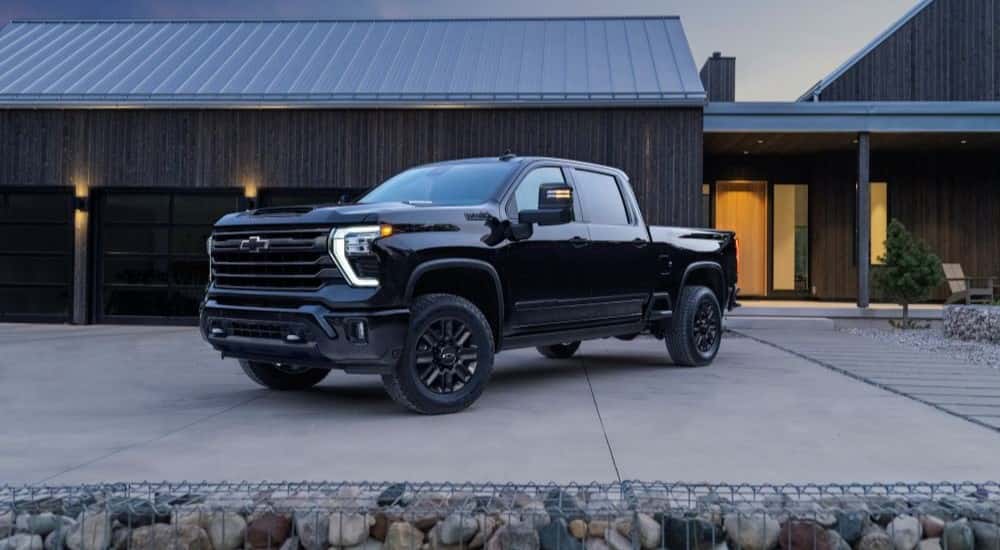 Black 2024 Chevy Silverado 2500 HD High Country parked at an angle