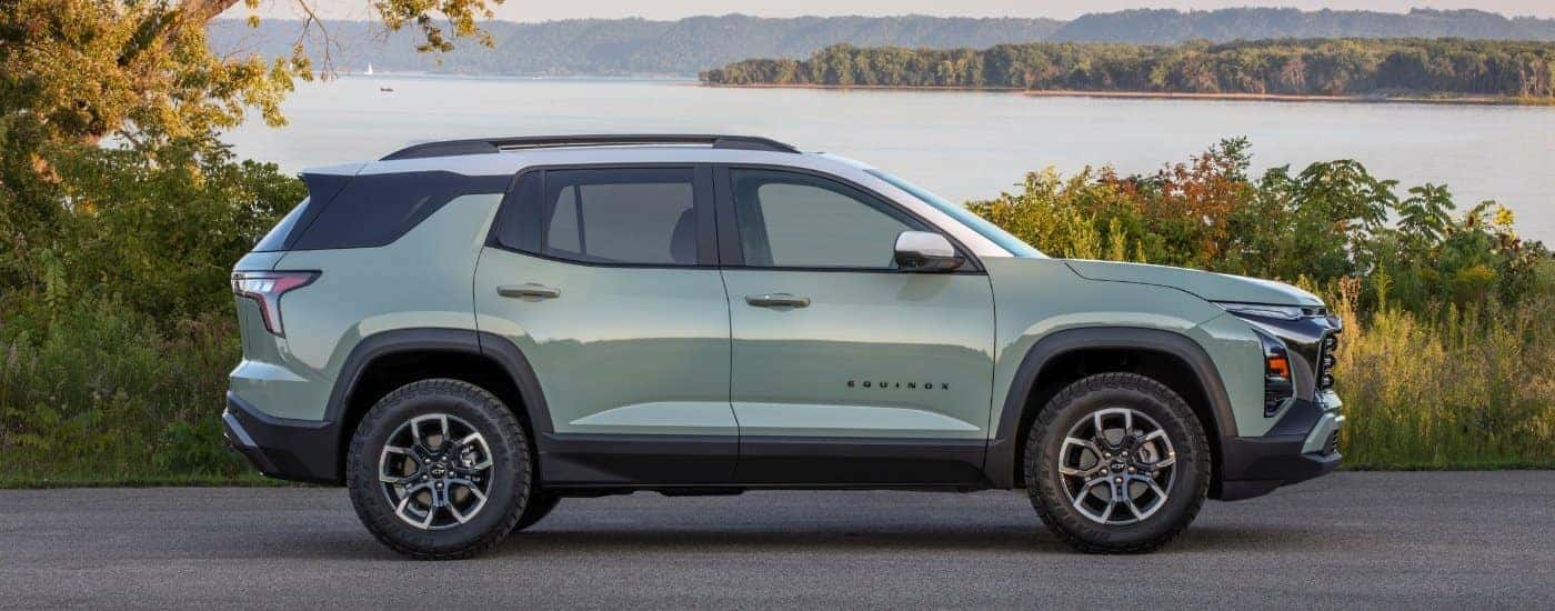 A green 2025 Chevy Equinox from the side.