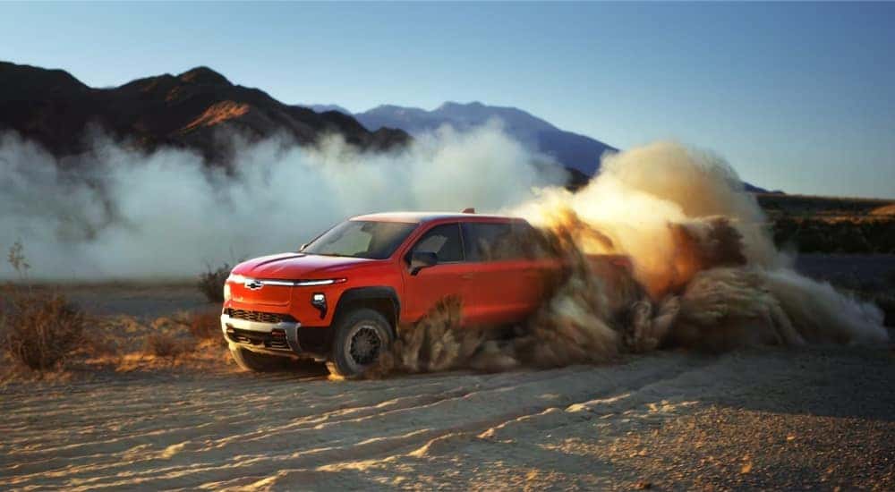 Red 2026 Chevy Silverado EV Trail Boss driving off road