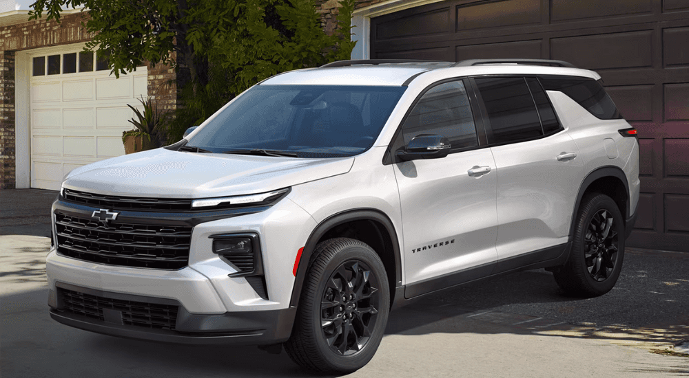 White 2026 Chevy Traverse parked in front of a house