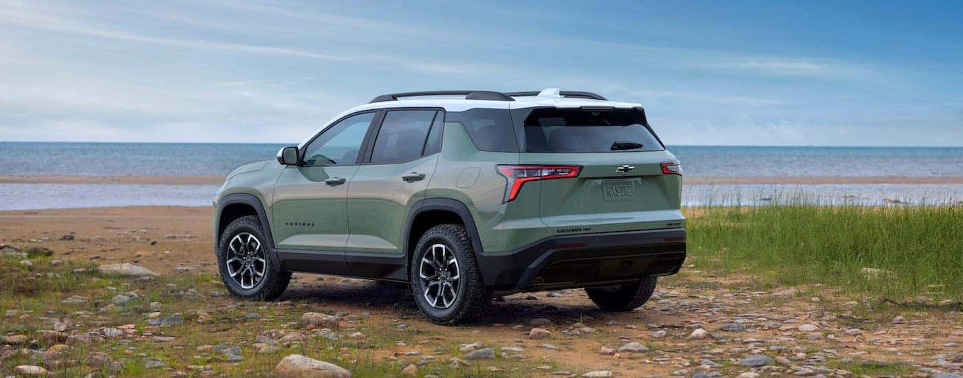 A green 2025 Chevy Equinox for sale near Niskayuna from the rear at an angle.