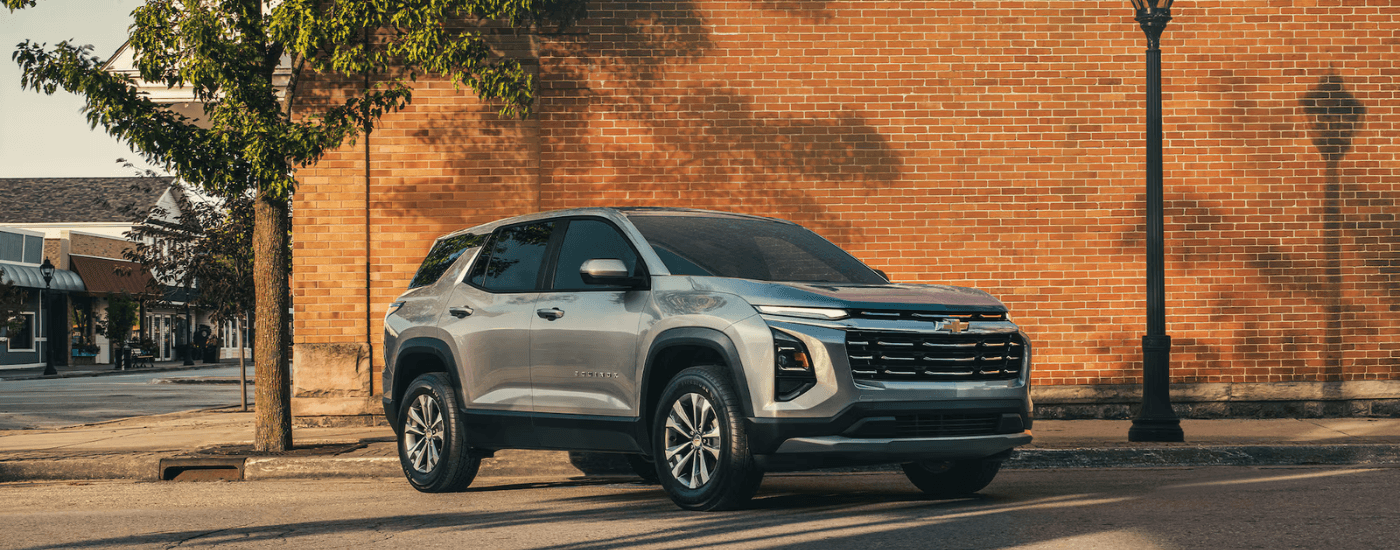 Silver 2026 Chevy Equinox parked in front of a brick building