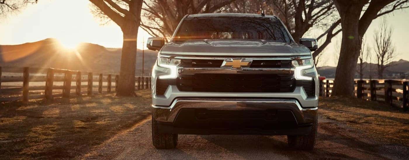 Silver 2023 Chevy Silverado 1500 driving to see vehicles for sale near Guilderland