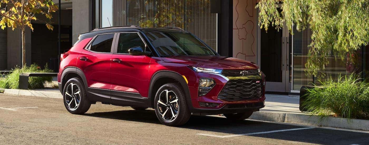 Red 2021 Chevy Trailblazer parked outside a used car dealer near Troy