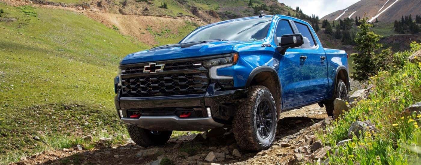 Blue 2022 Chevy Silverado 1500 ZR2 driving on a trail