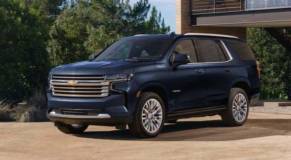 Blue 2023 Chevy Tahoe parked in front of a house