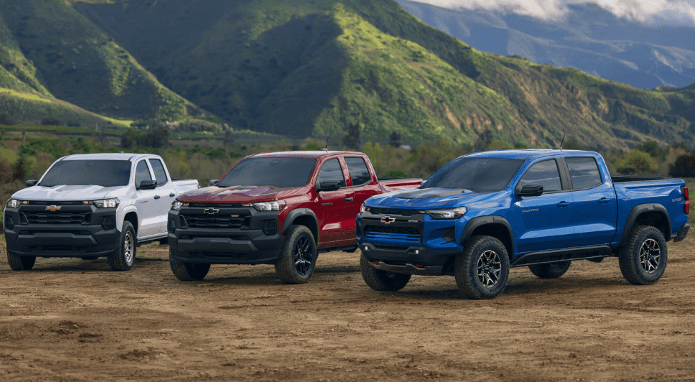 A white, a red, and a blue 2026 Chevy Colorado's parked side by side