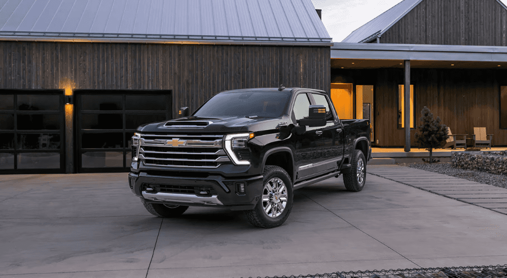 Black 2026 Chevy Silverado 2500 HD parked in front of a house