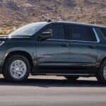 Black 2021 Chevy Suburban driving down the road