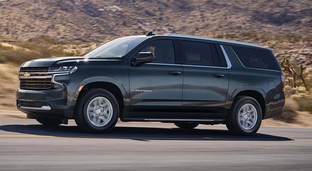 Black 2021 Chevy Suburban driving to a used car dealer near Troy