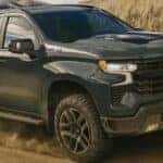 A green 2026 Chevy Silverado 1500 Z71 off-roading.