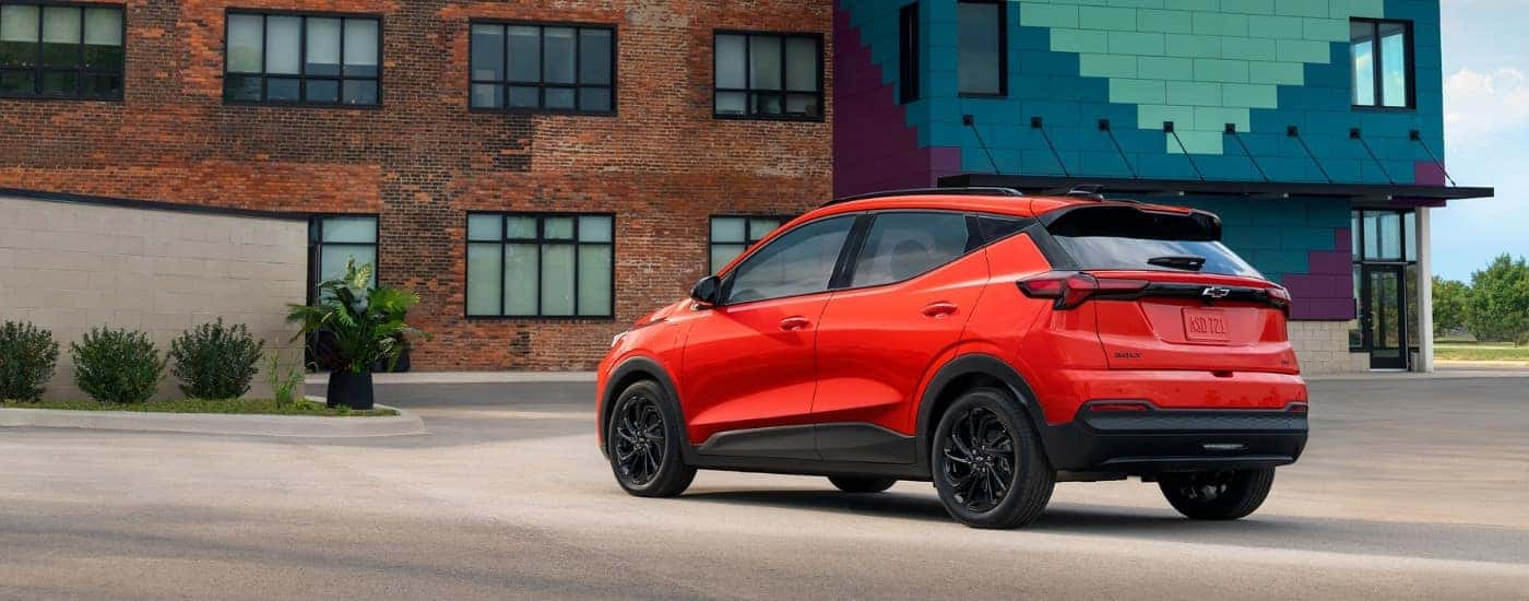 A red 2027 Chevy Bolt from the rear.