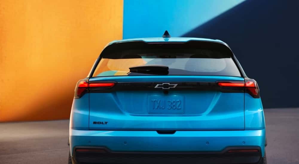 A blue 2027 Chevy Bolt from the rear.