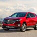 Red 2023 Chevy Equinox parked on pavement.