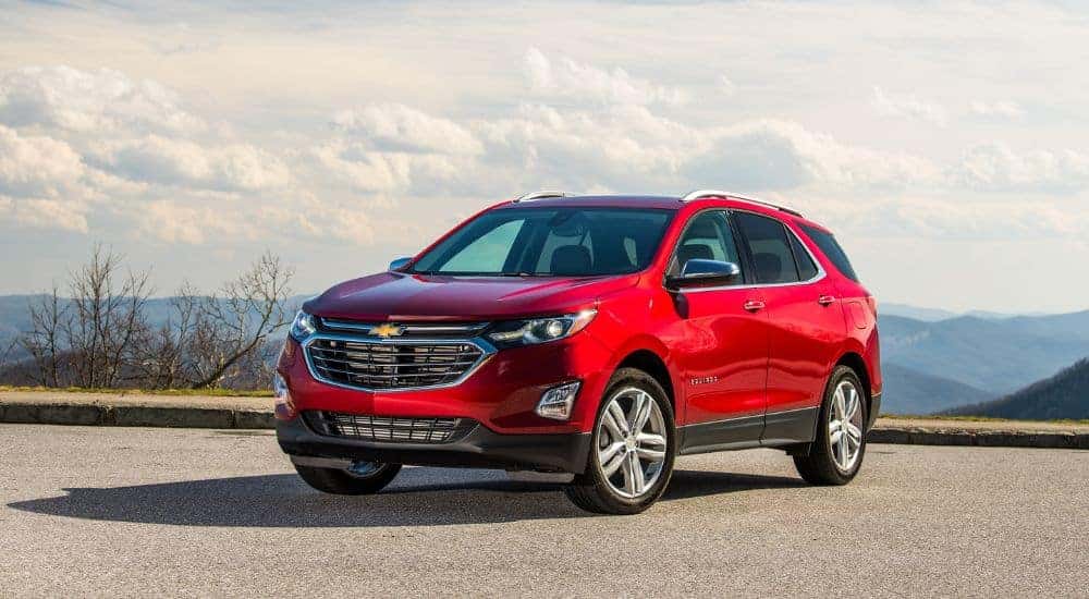 Red 2023 Chevy Equinox parked on pavement.