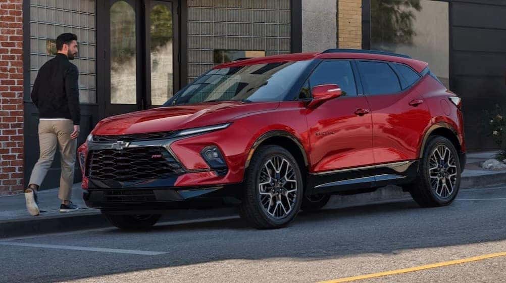 A red 2026 Chevy Blazer RS parked in a city.