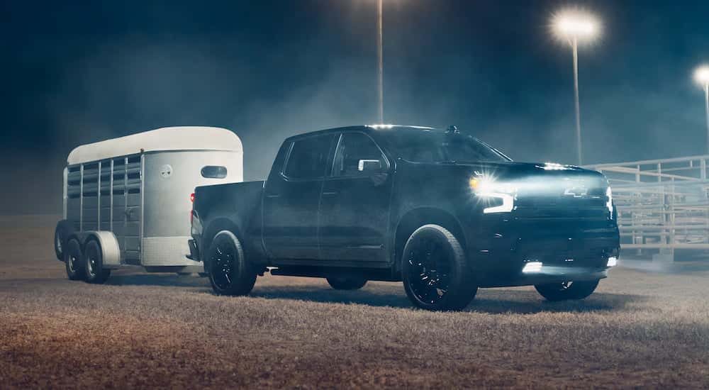 Black 2026 Chevy Silverado 1500 towing a trailer.