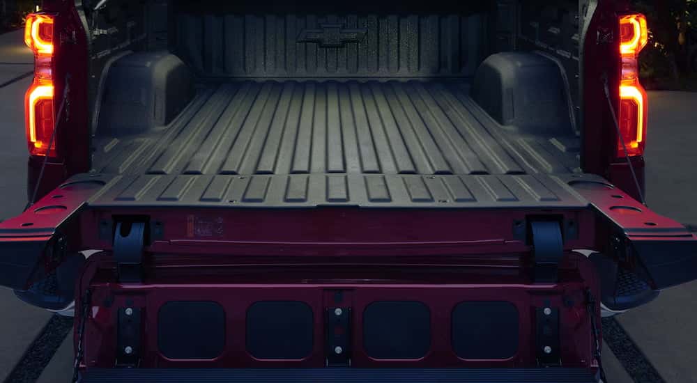Close-up on the open tailgate of a red 2026 Chevy Silverado 1500.