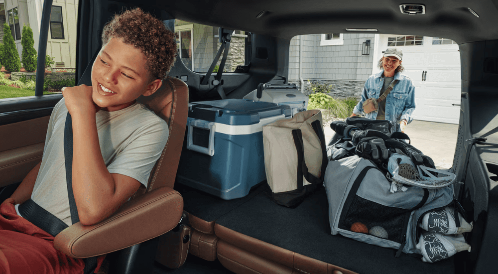 A parent loading the trunk of a 2026 Chevy Suburban