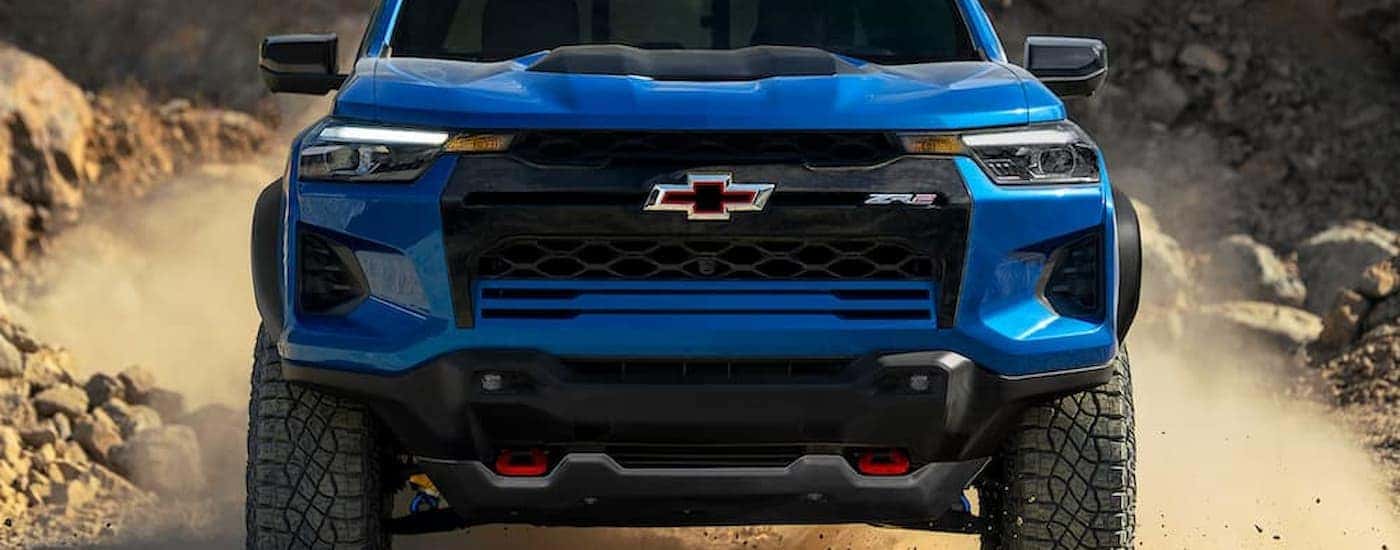 A blue 2025 Chevy Colorado off-roading on a dirt road
