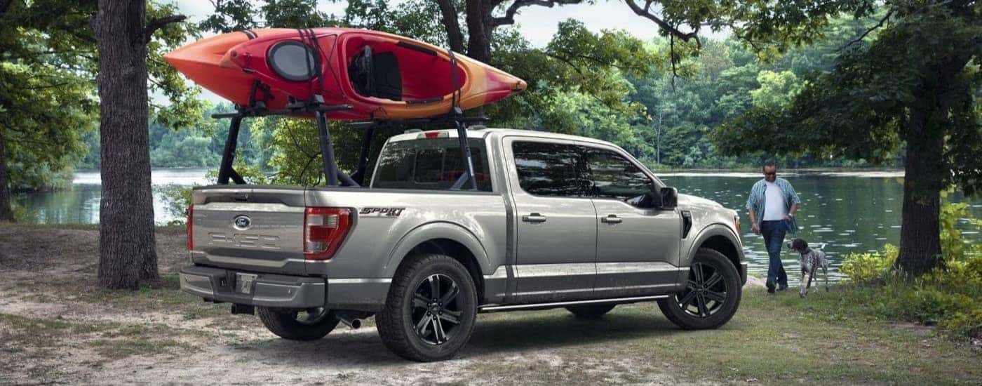 Grey 2023 Ford F-150 parked near a campsite with a kayak
