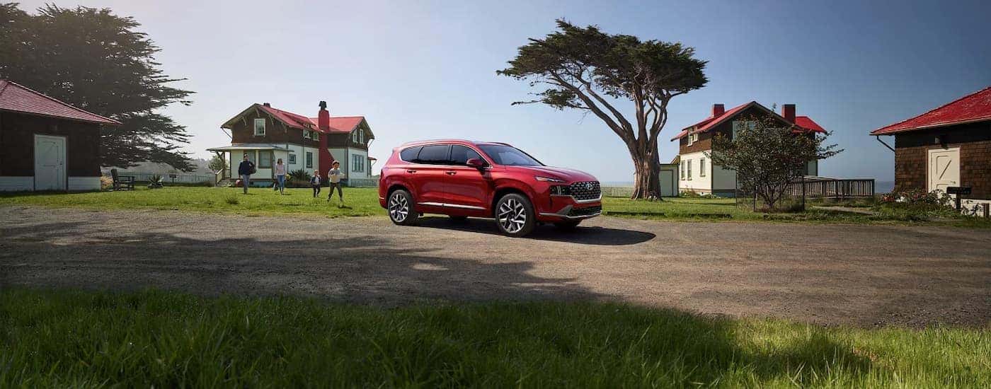 Red 2023 Hyundai Santa Fe parked in a driveway