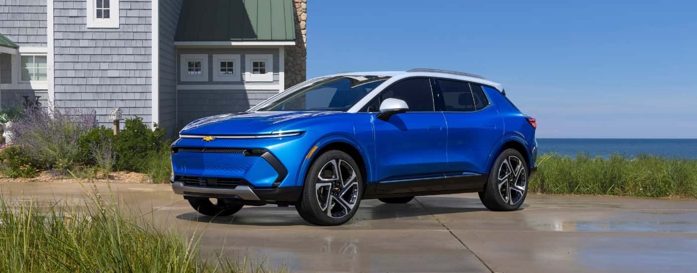 Blue 2024 Chevy Equinox EV for sale near Cohoes parked on a driveway