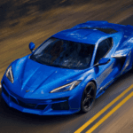 Blue 2026 Chevy Corvette E-Ray driving down a rural street