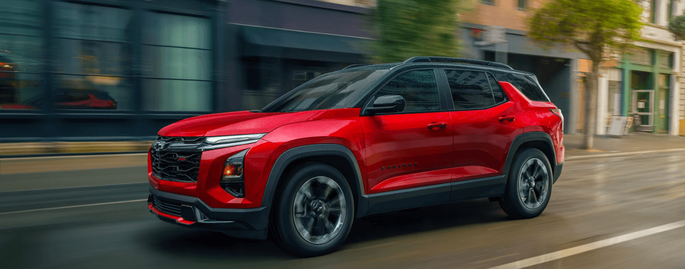 Red 2026 Chevy Equinox RS driving through a city