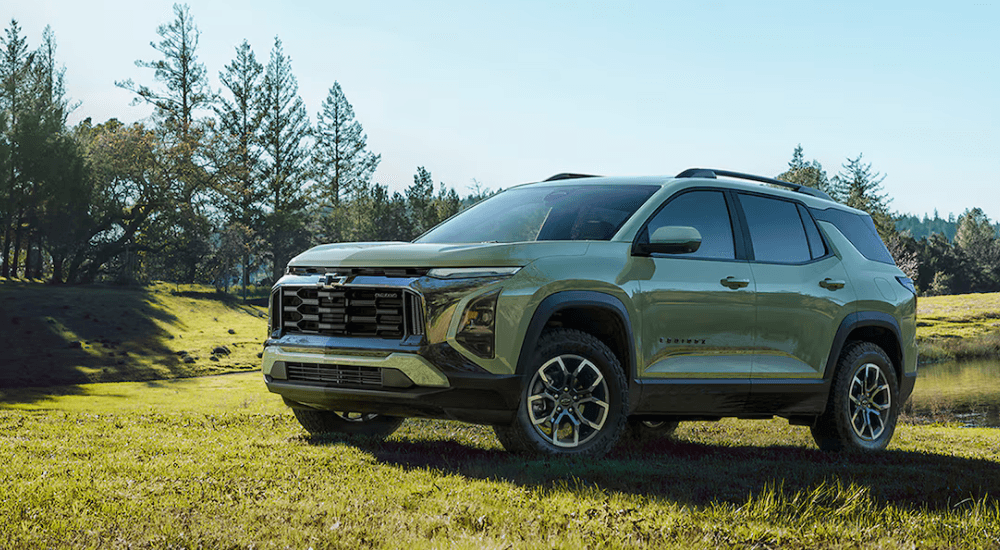 Green 2026 Chevy Equinox parked on a field