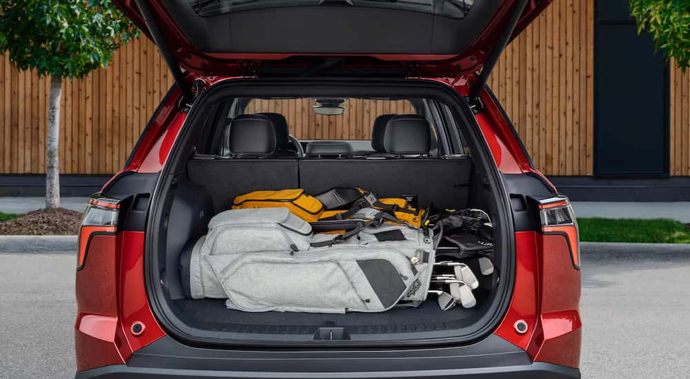 Golf clubs in the trunk of a red 2026 Chevy Equinox