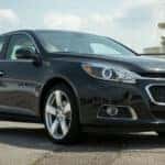 Black 2014 Chevy Malibu from the side