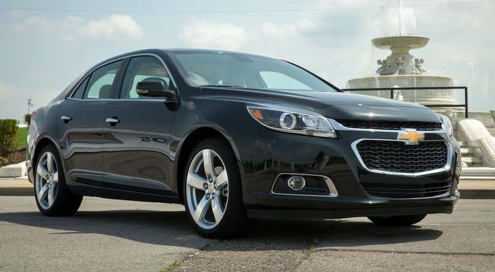 Black 2014 Chevy Malibu from the side