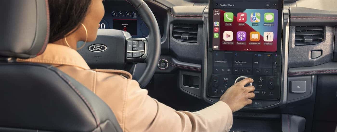 Woman using the infotainment screen in a 2022 Ford Expedition
