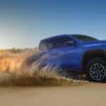 Blue 2026 Chevy Colorado driving through sand