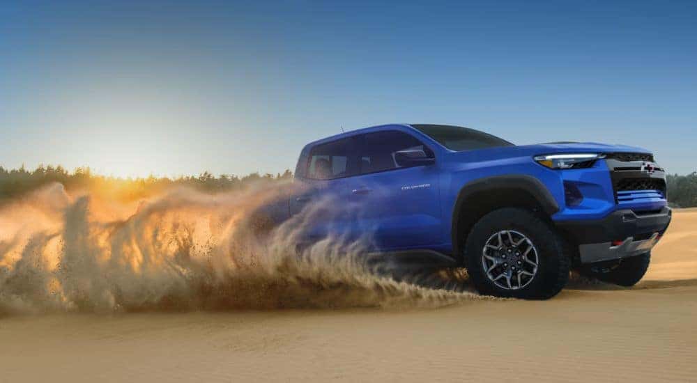 Blue 2026 Chevy Colorado driving through sand