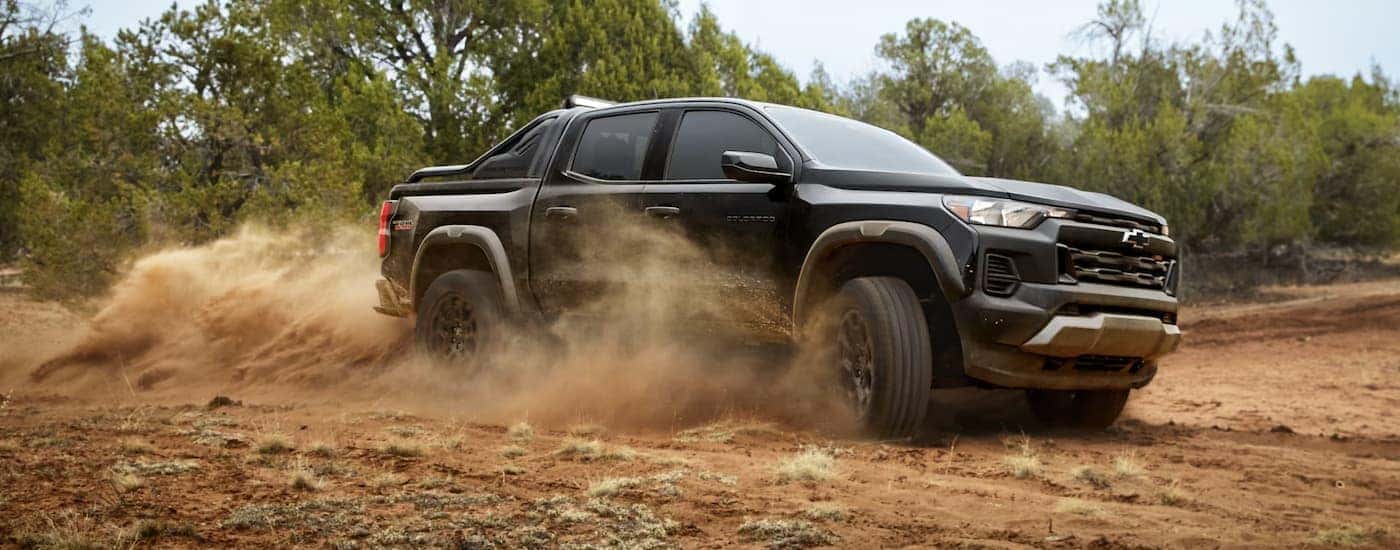 Black 2026 Chevy Colorado off-roading on a dirt trail