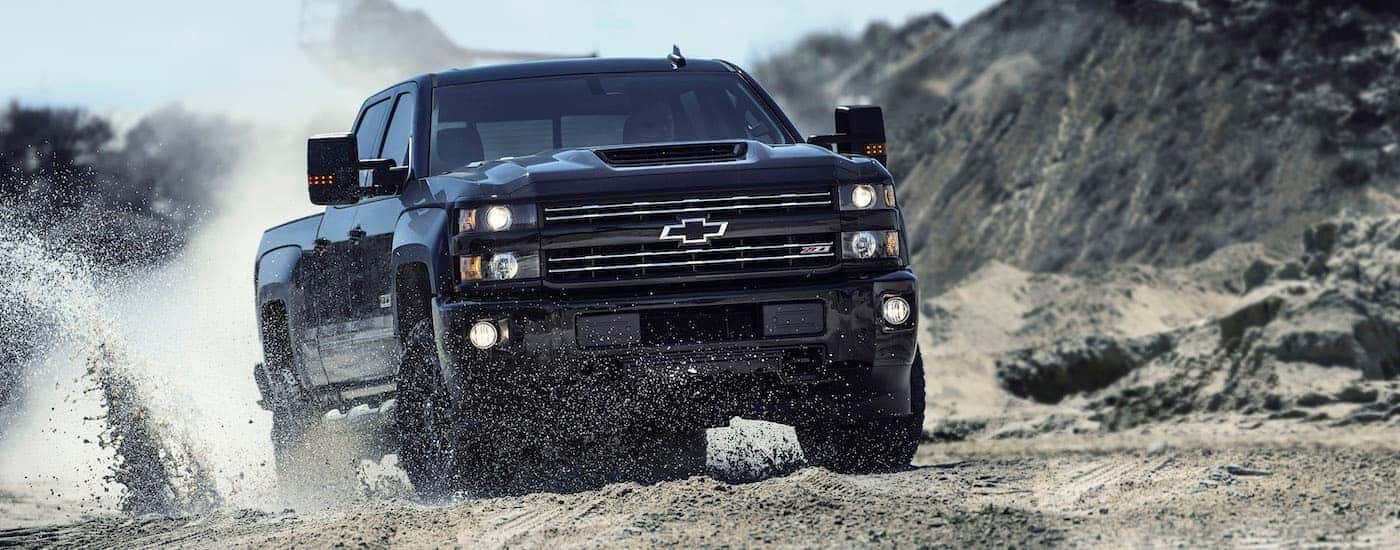 Black 2017 Chevy Silverado 2500 HD driving up a mountain.