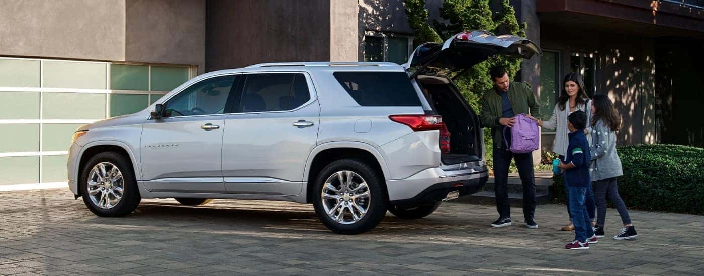 White 2022 Chevy Traverse with a family at the cargo area.