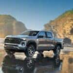 A silver 2023 Chevy Colorado Z71 driving on a beach.