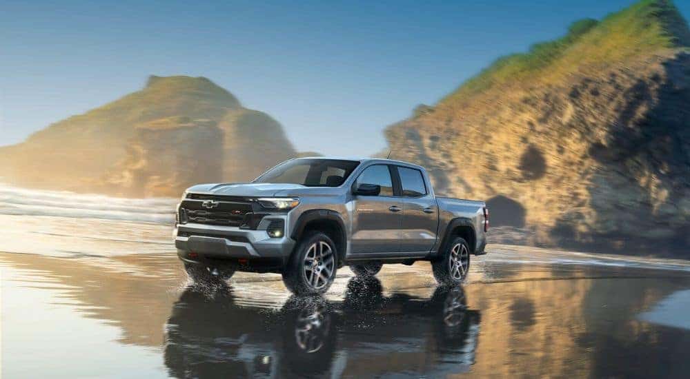 A silver 2023 Chevy Colorado Z71 driving on a beach.
