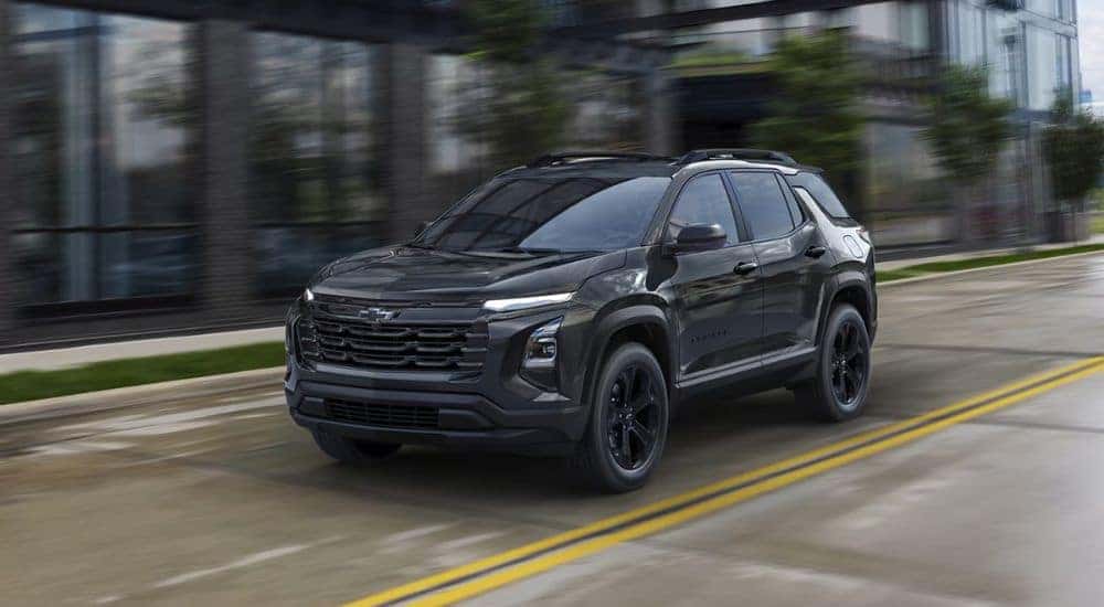 Black 2026 Chevy Equinox driving on a city road.