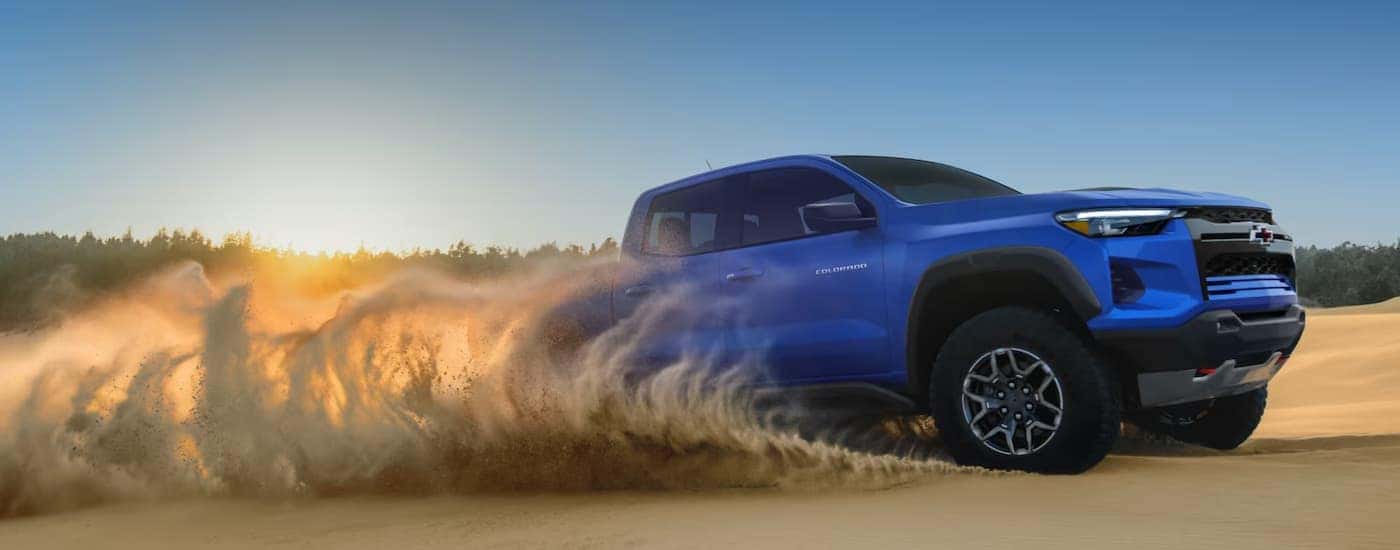 A blue 2026 Chevy Colorado off-roading in sand