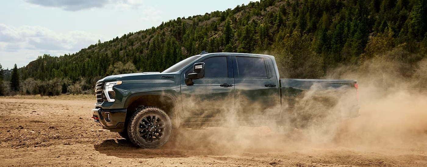 A green 2026 Chevy Silverado 2500 HD off-roading.