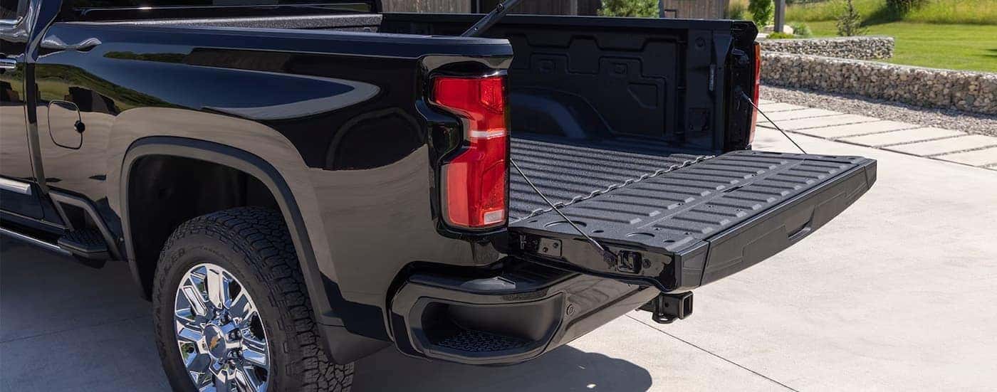 Open tailgate on a black 2026 Chevy Silverado 2500 HD.